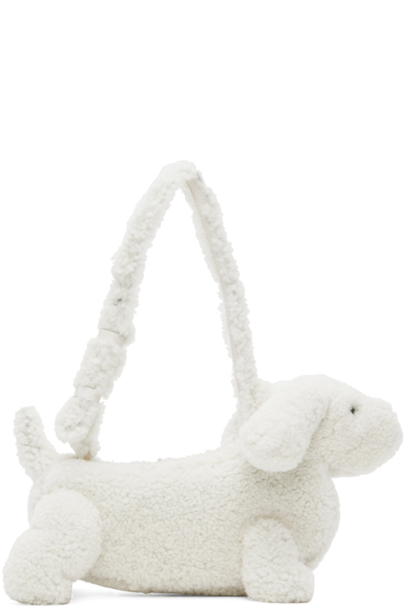 Sculptural Merino shearling shoulder bag in white. Grained calfskin trim in black throughout.

· Rolled carry handle
· Zip closure
· Patch pocket at interior
· Signature tricolor twill lining
· Logo-engraved gold-tone hardware
· H9 x W14 x D6 in

Supplier color: White