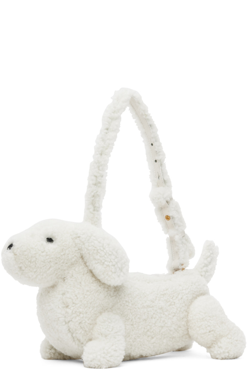 Sculptural Merino shearling shoulder bag in white. Grained calfskin trim in black throughout.

· Rolled carry handle
· Zip closure
· Patch pocket at interior
· Signature tricolor twill lining
· Logo-engraved gold-tone hardware
· H9 x W14 x D6 in

Supplier color: White
