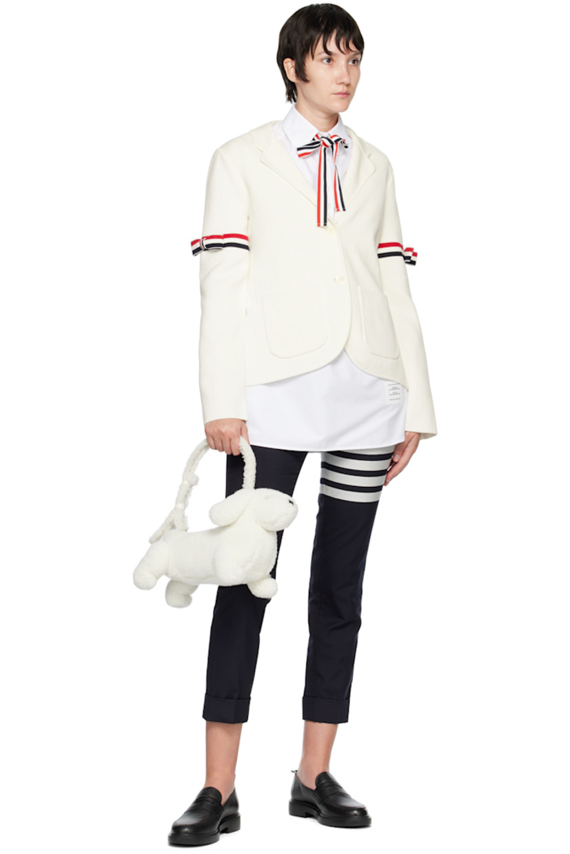 Sculptural Merino shearling shoulder bag in white. Grained calfskin trim in black throughout.

· Rolled carry handle
· Zip closure
· Patch pocket at interior
· Signature tricolor twill lining
· Logo-engraved gold-tone hardware
· H9 x W14 x D6 in

Supplier color: White