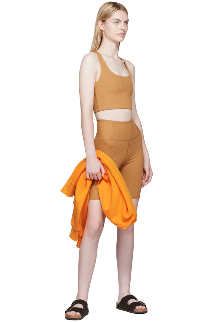 Rib knit stretch recycled polyester sport shorts. 

· High-rise 
· Elasticized waistband
· Concealed welt pocket at back waistband
· Partial jersey lining

Supplier color: Toffee