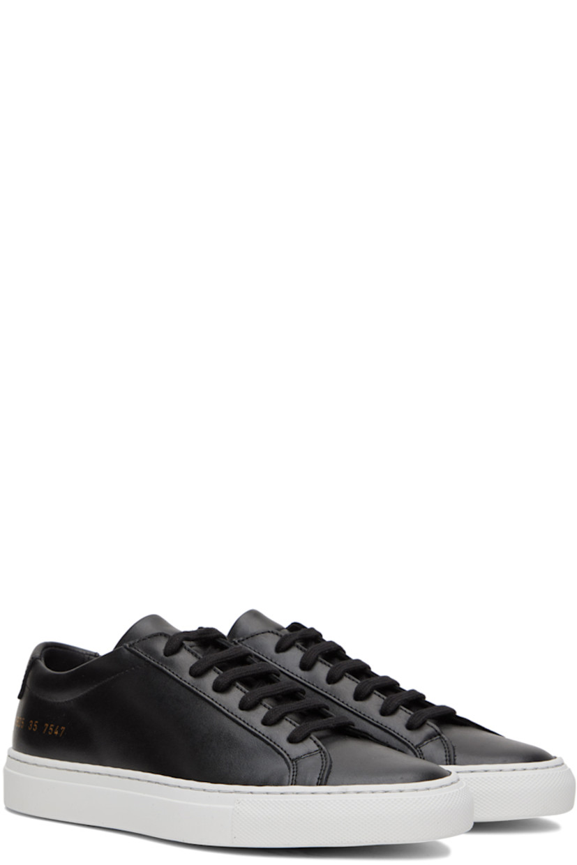 Low-top buffed leather sneakers in black. 

· Lace-up closure
· Padded tongue and collar
· Text printed in gold-tone at outer side
· Treaded rubber sole

Supplier color: Black