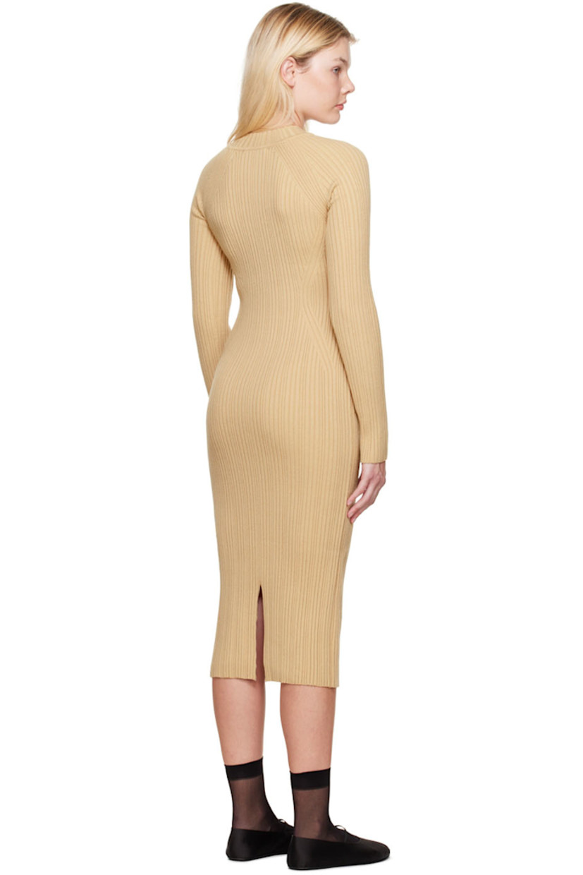 Rib knit acrylic and wool-blend dress. 

· Mock neck 
· Cutouts at front 
· Central vent at back hem

Supplier color: Beige