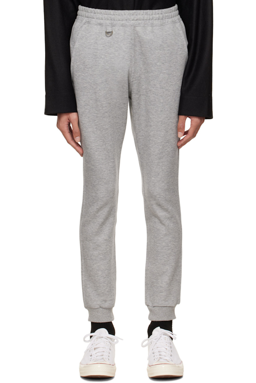 Cotton and polyester-blend jersey lounge pants.

· Logo-engraved D-ring hardware at elasticized waistband
· Three-pocket styling
· Logo printed at front
· Rib knit elasticized cuffs
· Text printed at back 

Supplier color: Gray