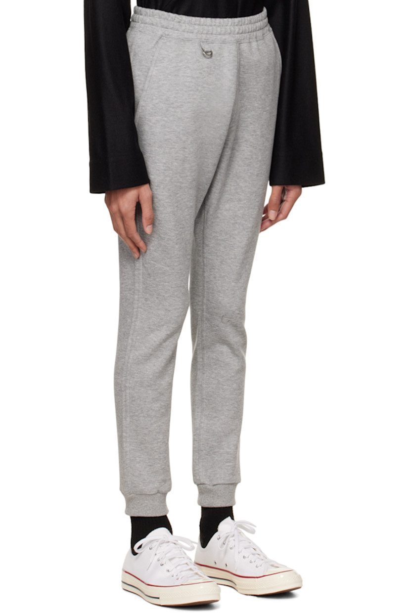 Cotton and polyester-blend jersey lounge pants.

· Logo-engraved D-ring hardware at elasticized waistband
· Three-pocket styling
· Logo printed at front
· Rib knit elasticized cuffs
· Text printed at back 

Supplier color: Gray