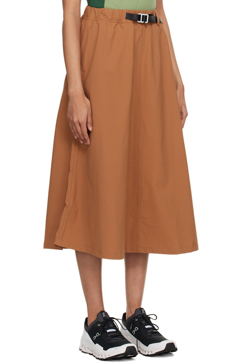 Stretch recycled nylon sport skirt. Moisture-wicking and water-repellent. 

· Integrated press-release belt at elasticized waistband 
· Two-pocket styling 
· Logo printed at front 
· Bungee-style drawstrings at side-seams 
· Locker loop at back waistband 

Supplier color: Brown sugar