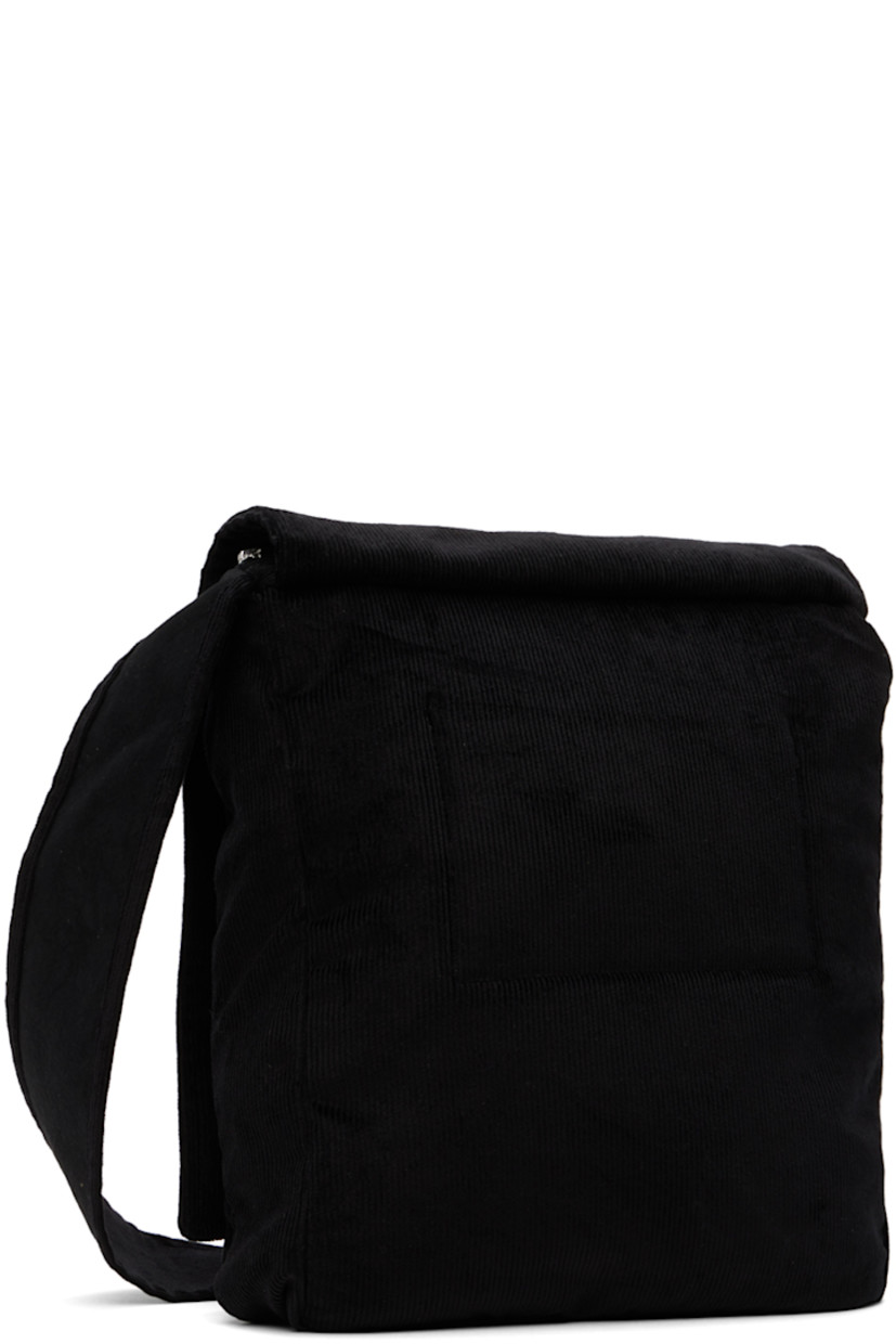 Stretch cotton corduroy shoulder bag in black. Logo graphic embroidered at foldover flap and face.

· Fixed shoulder strap
· Zip closure  
· Concealed zip pocket at interior 
· Plain-woven cotton lining in black
· H13 x W11 x D2 in

Supplier color: Black
