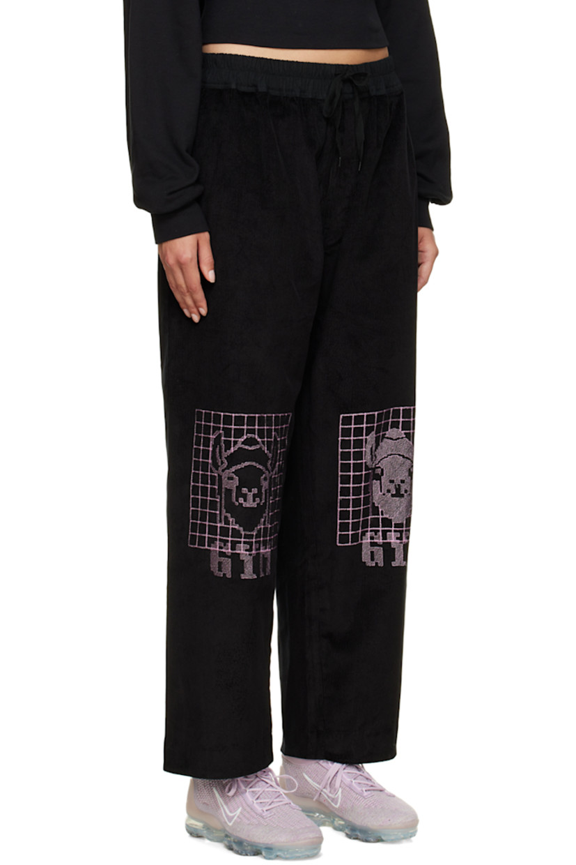 Wide-leg stretch cotton corduroy lounge pants. 

· Drawstring at elasticized waistband
· Three-pocket stylng
· Button-fly
· Graphics embroidered at front

Supplier color: Black