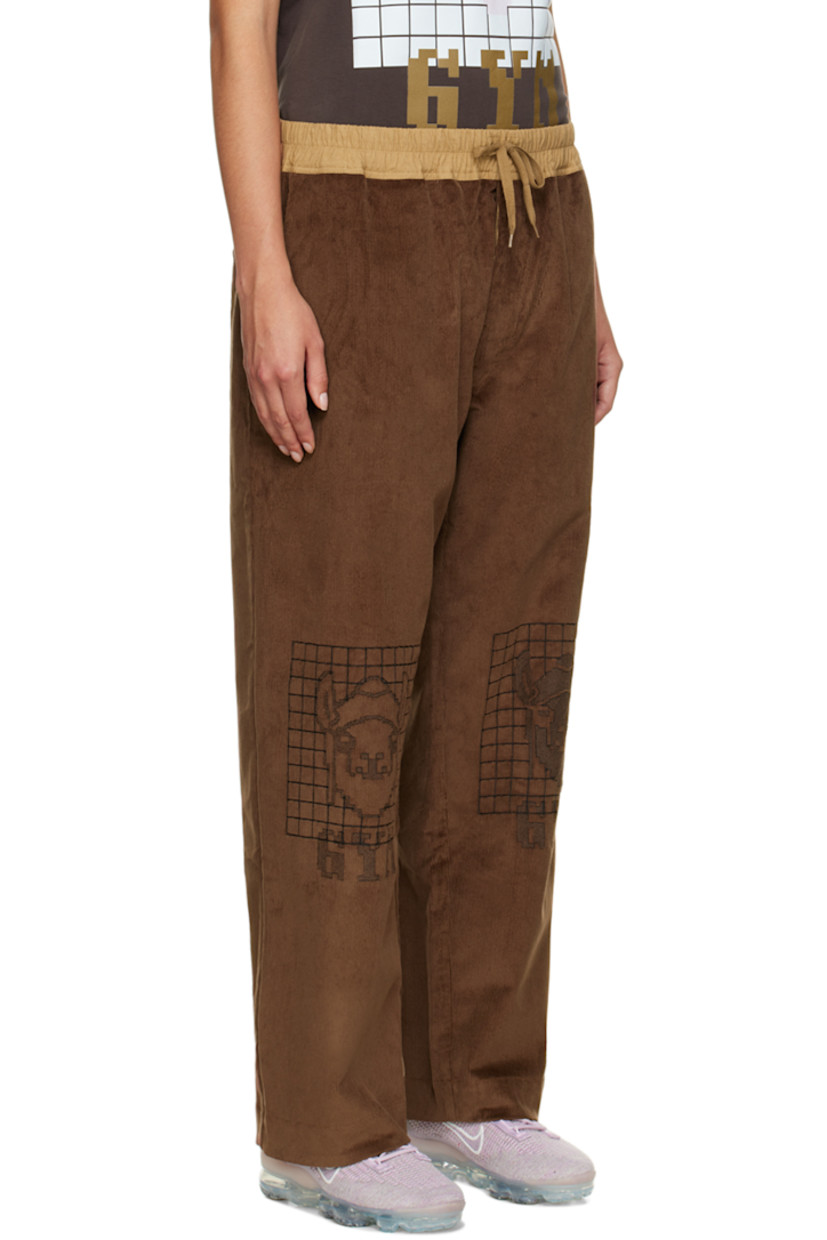 Wide-leg stretch cotton corduroy lounge pants. 

· Drawstring at elasticized waistband
· Three-pocket stylng
· Button-fly
· Graphics embroidered at front

Supplier color: Brown