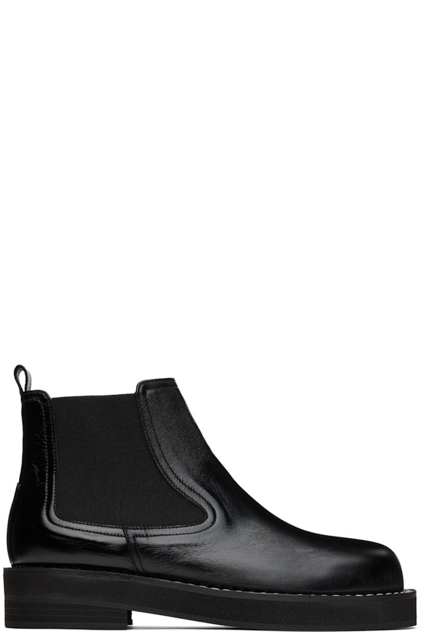 Ankle-high buffed leather boots in black. 

· Pull-loop at heel collar
· Elasticized gussets at sides
· Topstitching at welt
· Foam rubber midsole
· Rubber outsole

Wholesale exclusivity at SSENSE.

Supplier color: Black