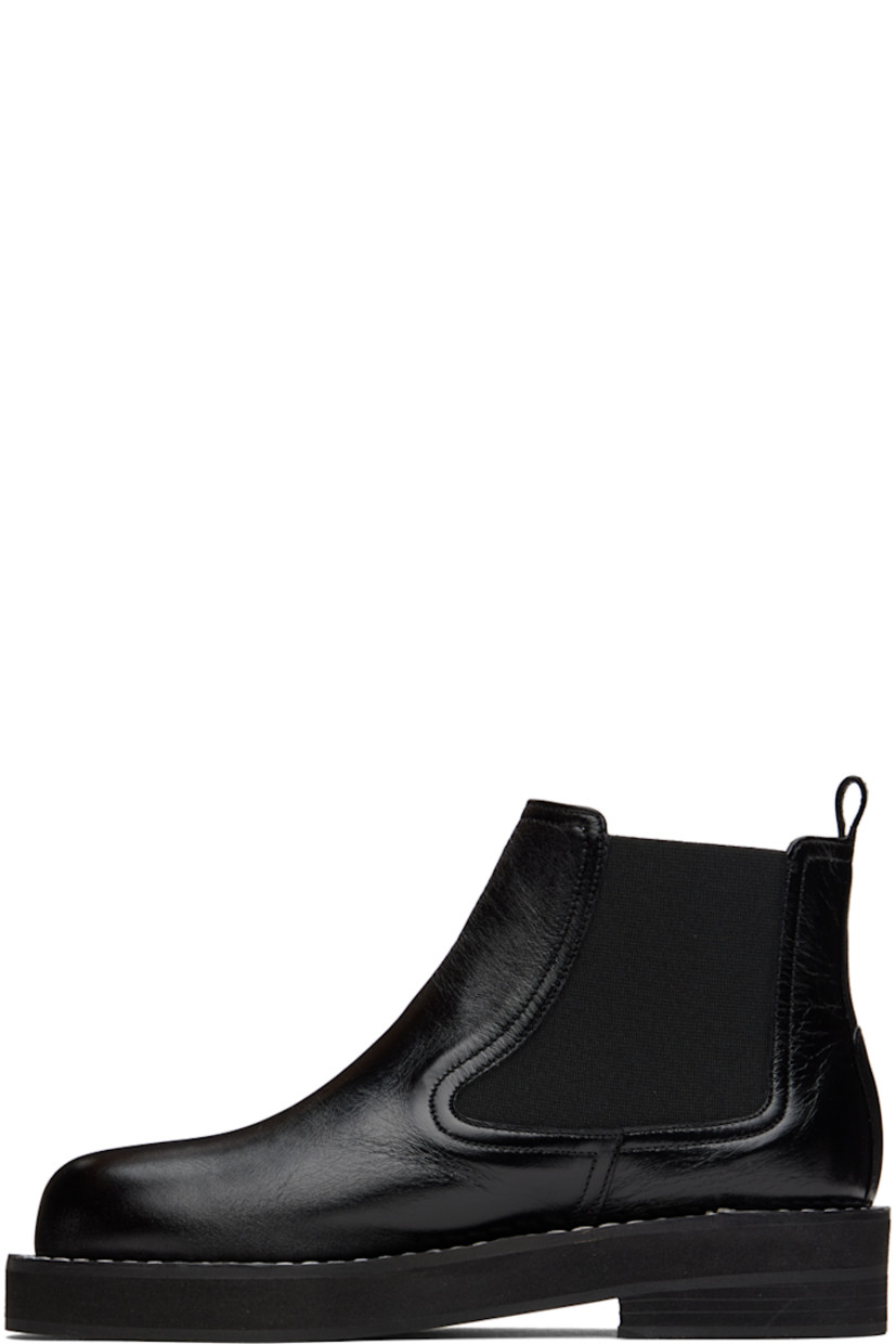 Ankle-high buffed leather boots in black. 

· Pull-loop at heel collar
· Elasticized gussets at sides
· Topstitching at welt
· Foam rubber midsole
· Rubber outsole

Wholesale exclusivity at SSENSE.

Supplier color: Black