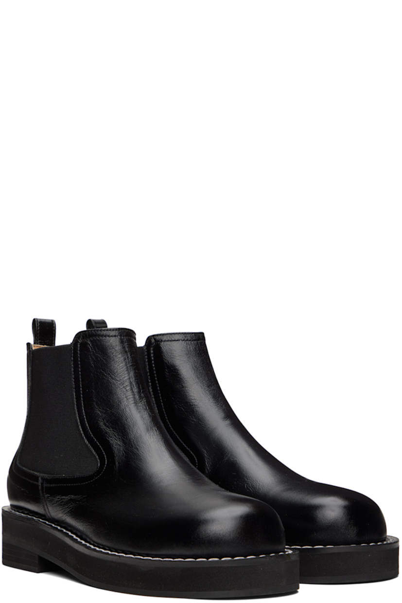 Ankle-high buffed leather boots in black. 

· Pull-loop at heel collar
· Elasticized gussets at sides
· Topstitching at welt
· Foam rubber midsole
· Rubber outsole

Wholesale exclusivity at SSENSE.

Supplier color: Black