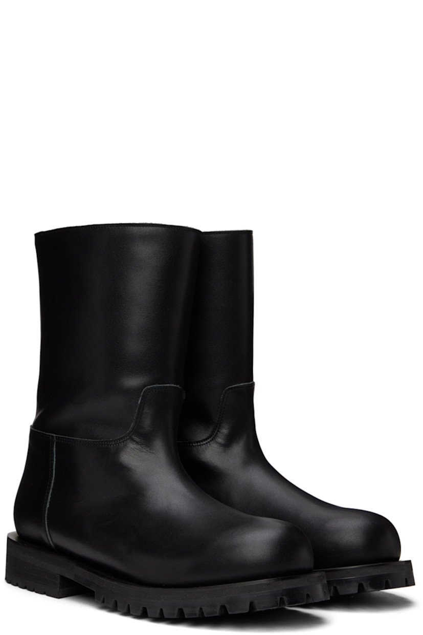 Ankle-high paneled buffed kip leather boots in black.

· Zip closure at heel counter
· Shearling and leather lining
· Stacked block heel
· Treaded rubber sole
· Heel: H1.2 in

Available exclusively at SSENSE.

Supplier color: Black