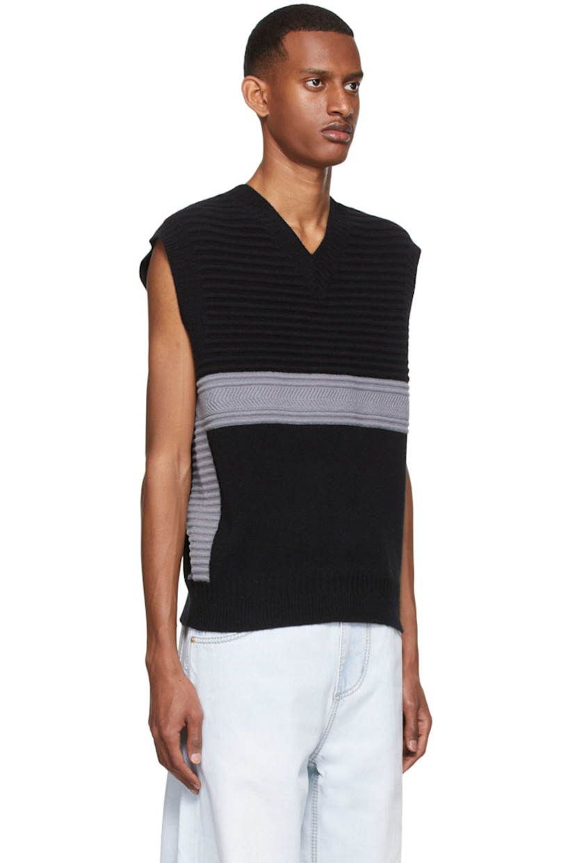 Knit merino wool vest.

· V-neck
· Rubber logo patch at back collar
· Rib knit collar and hem

Supplier color: Stone black