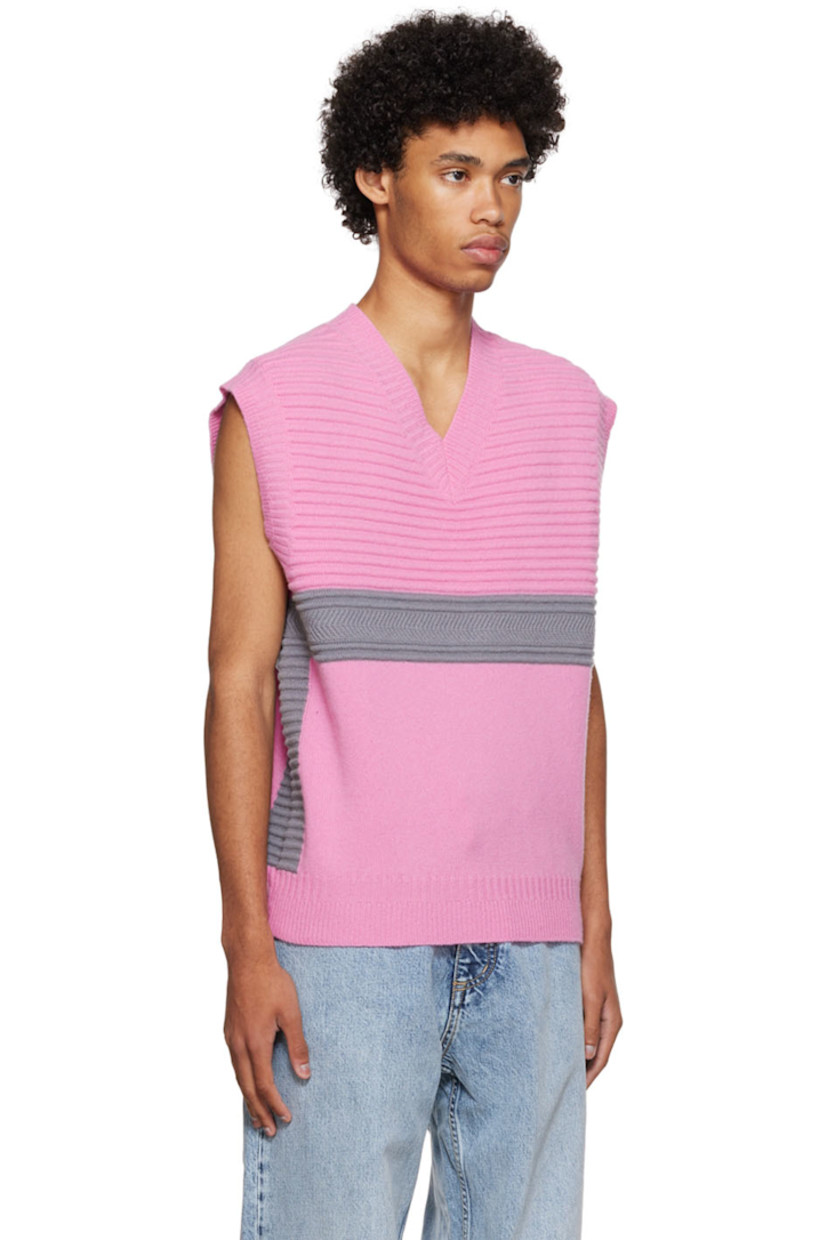 Knit merino wool vest.

· Rib knit V-neck, armscyes, and hem
· Rubberized logo patch at back

Available exclusively at SSENSE.

Supplier color: Pink lemonade