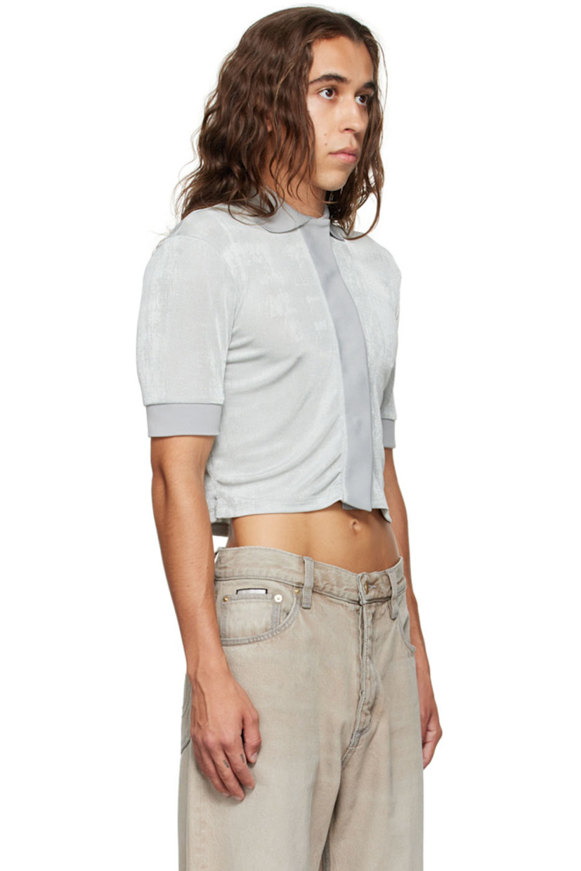 Stretch polyester jersey polo.

· Rib knit spread collar and cuffs
· Concealed press-stud closure
· Logo embroidered at front hem

Supplier color: Oyster