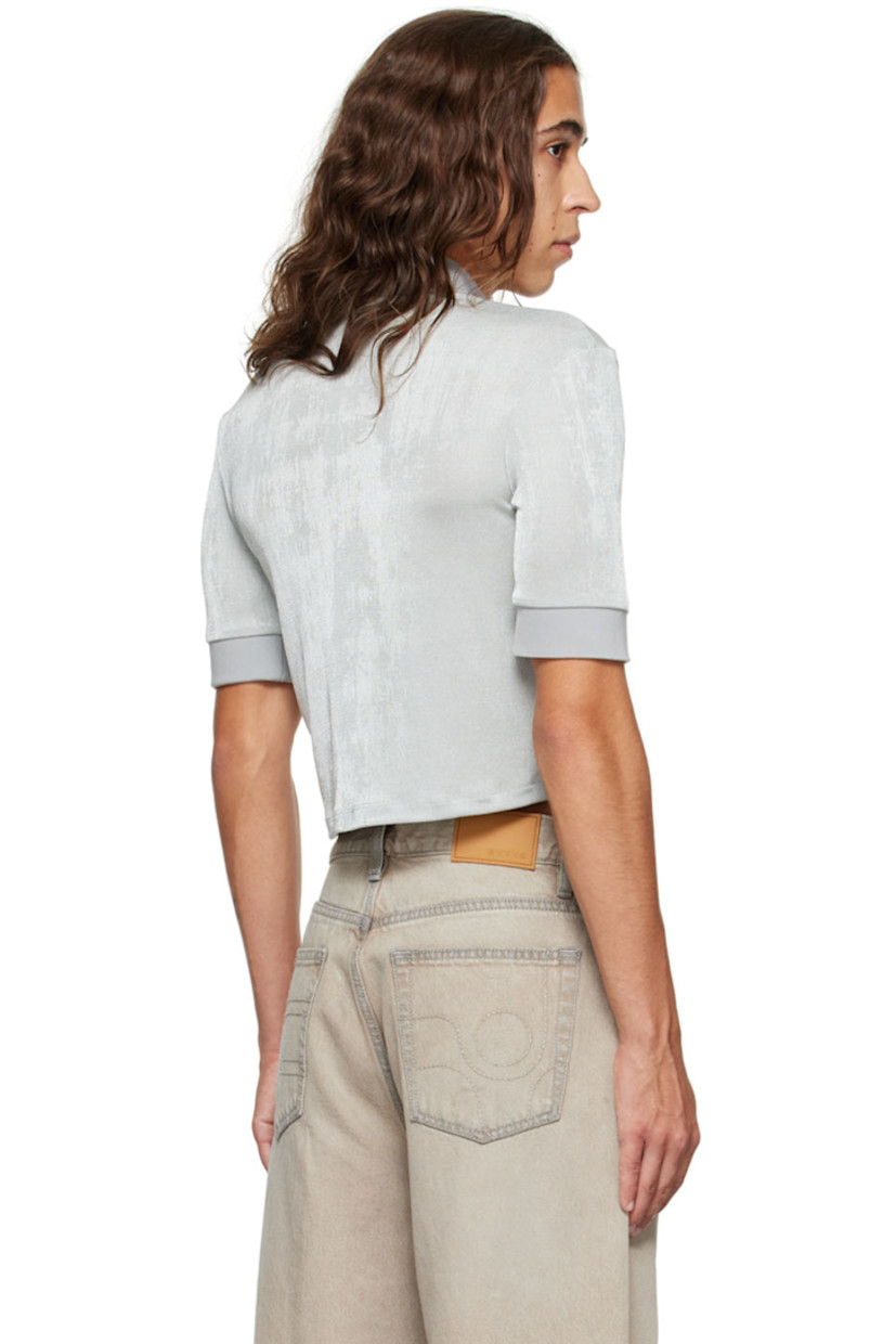 Stretch polyester jersey polo.

· Rib knit spread collar and cuffs
· Concealed press-stud closure
· Logo embroidered at front hem

Supplier color: Oyster