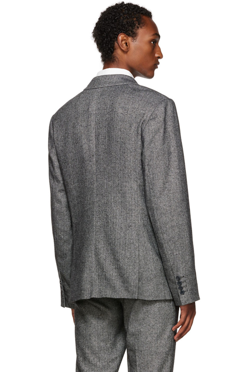 Wool-blend herringbone blazer. 

· Notched lapel
· Single-breasted button closure 
· Flap pockets 
· Four-button surgeon's cuffs 
· Central vent at back hem 
· Full satin lining 

Supplier color: Black