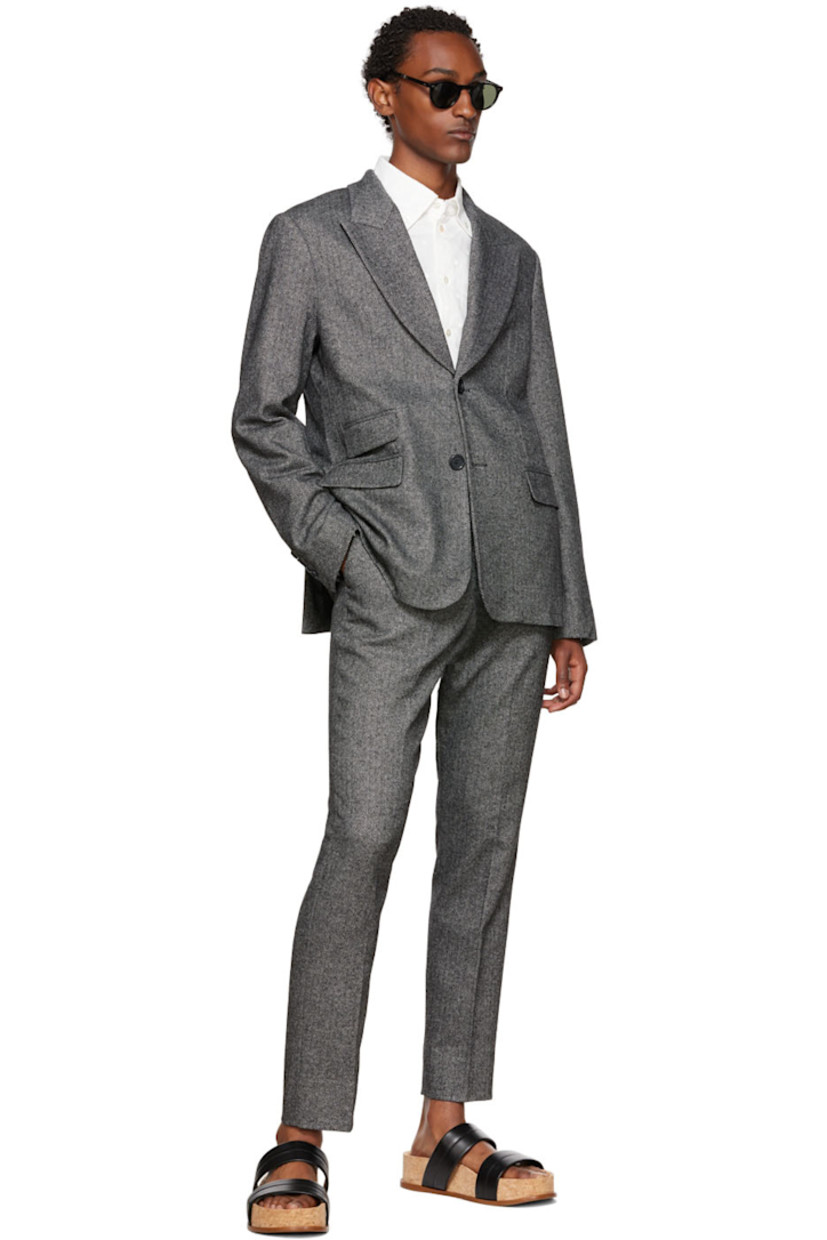 Wool-blend herringbone blazer. 

· Notched lapel
· Single-breasted button closure 
· Flap pockets 
· Four-button surgeon's cuffs 
· Central vent at back hem 
· Full satin lining 

Supplier color: Black
