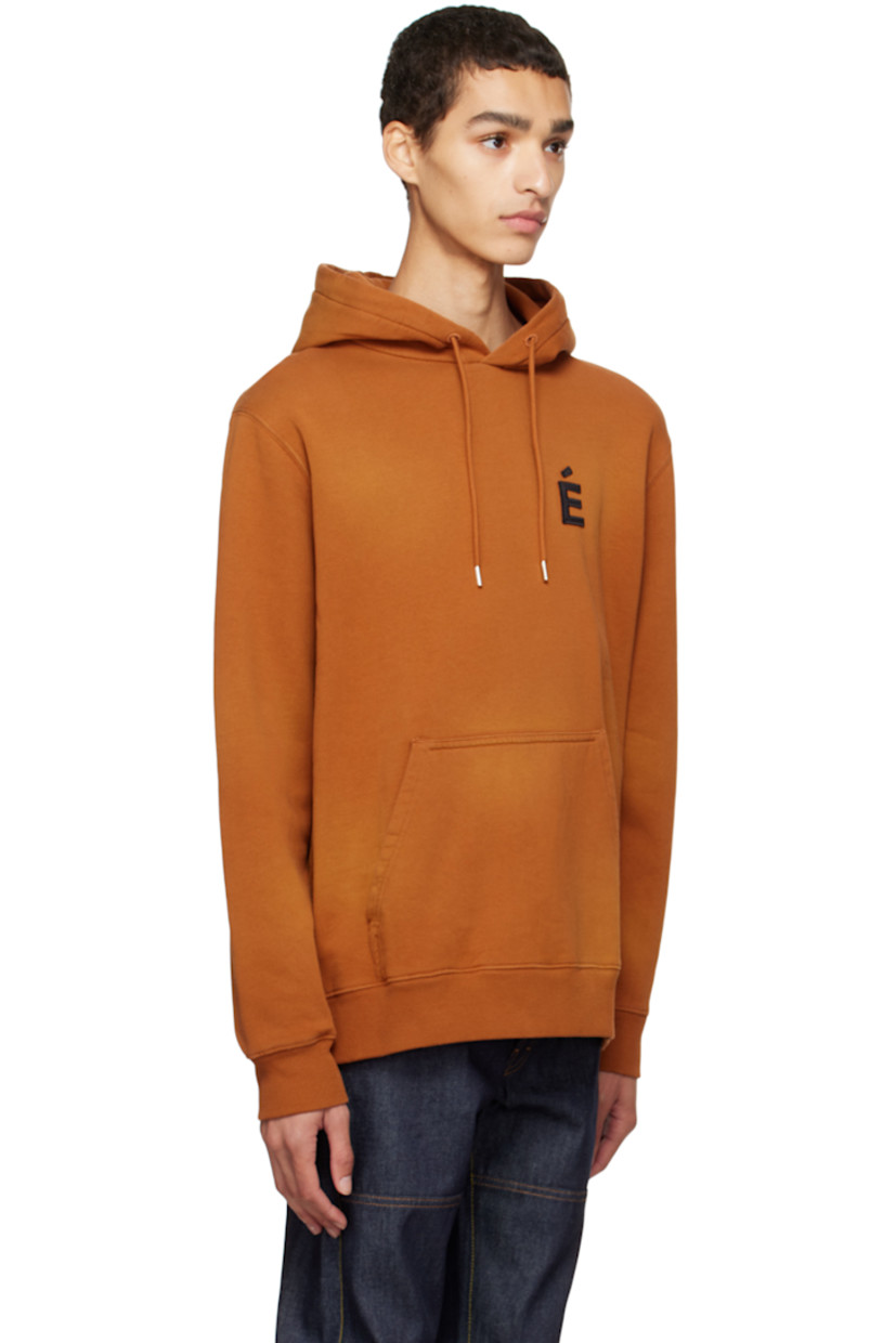 Organic cotton fleece hoodie. Fading throughout.

· Drawstring at hood
· Embroidered logo patch at chest
· Kangaroo pocket
· Rib knit hem and cuffs

Supplier color: Spray brown