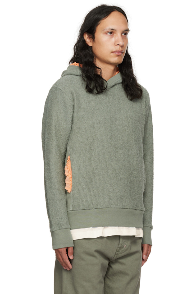 Reversed French terry hoodie.

· Ruffled trim at hood and kangaroo pocket
· Rib knit collar, side seams, cuffs, and hem

Supplier color: Green/peach