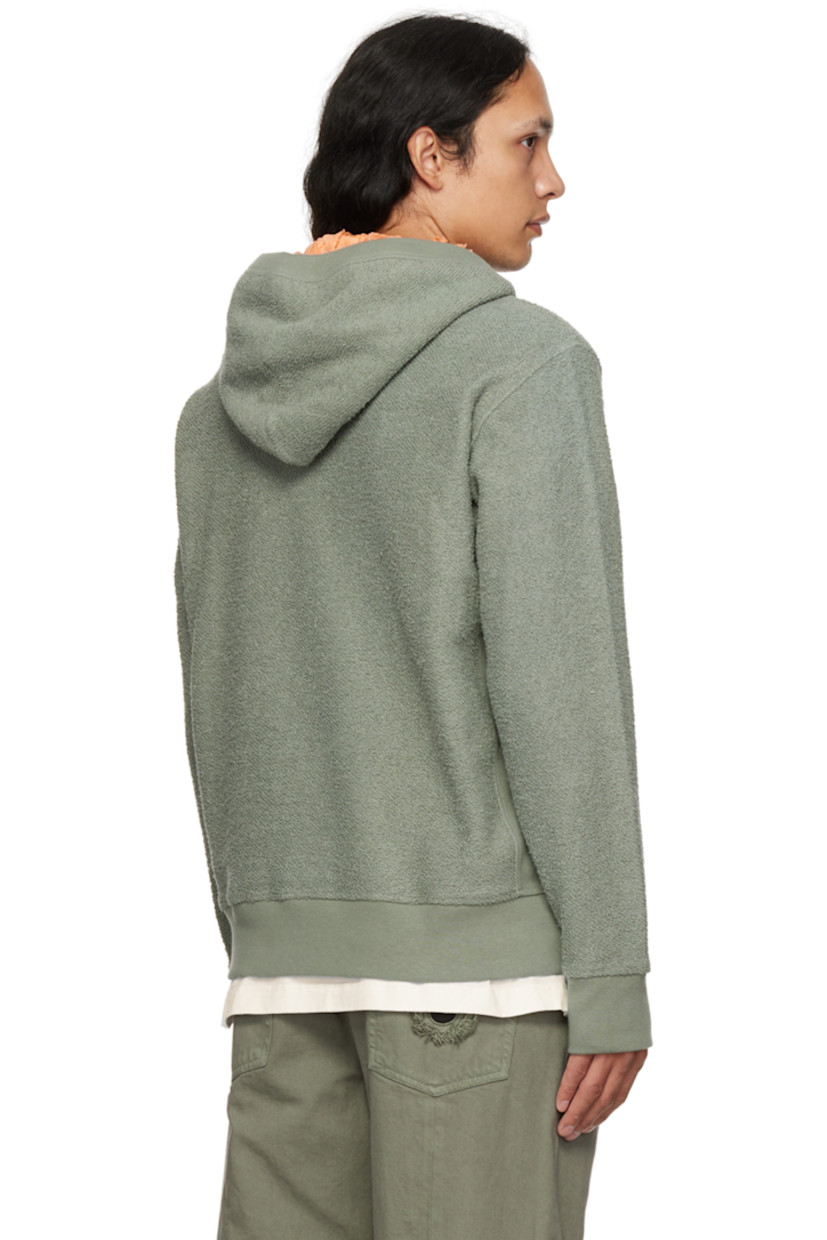 Reversed French terry hoodie.

· Ruffled trim at hood and kangaroo pocket
· Rib knit collar, side seams, cuffs, and hem

Supplier color: Green/peach