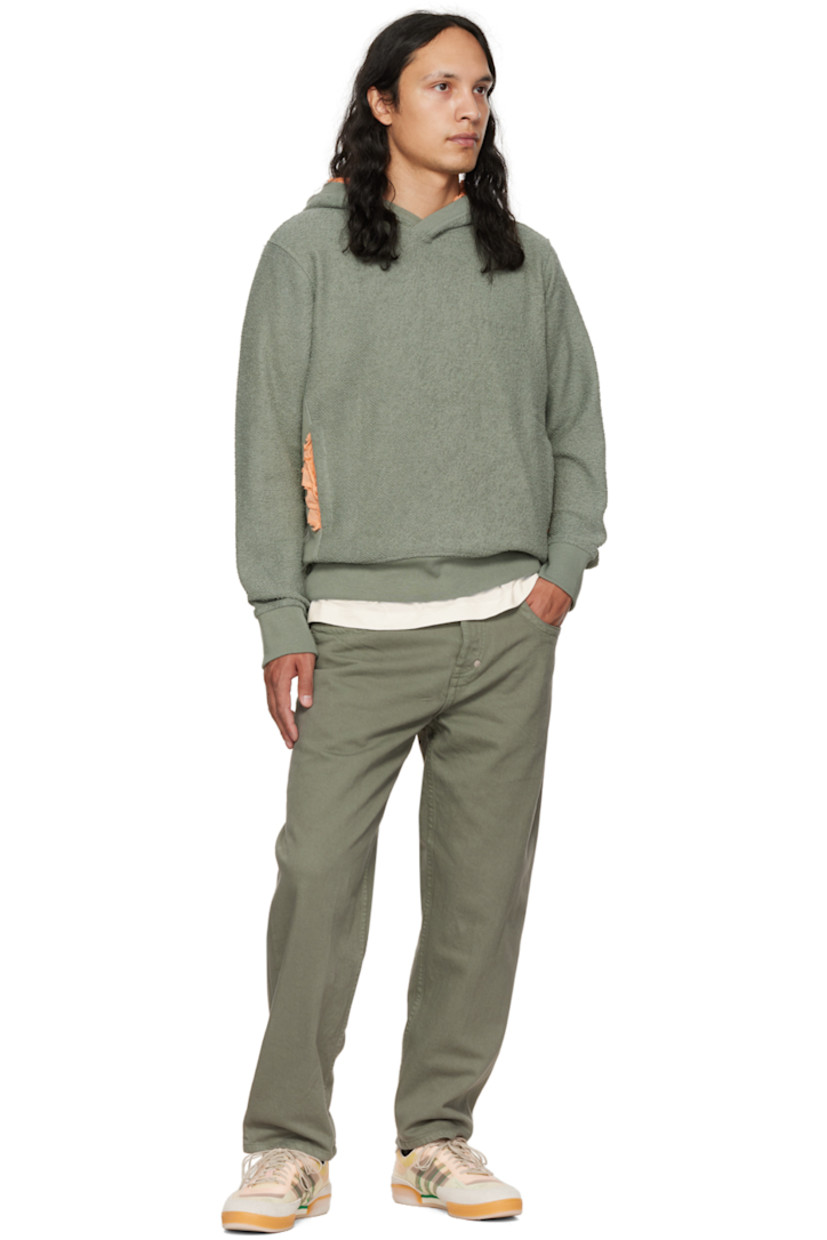 Reversed French terry hoodie.

· Ruffled trim at hood and kangaroo pocket
· Rib knit collar, side seams, cuffs, and hem

Supplier color: Green/peach