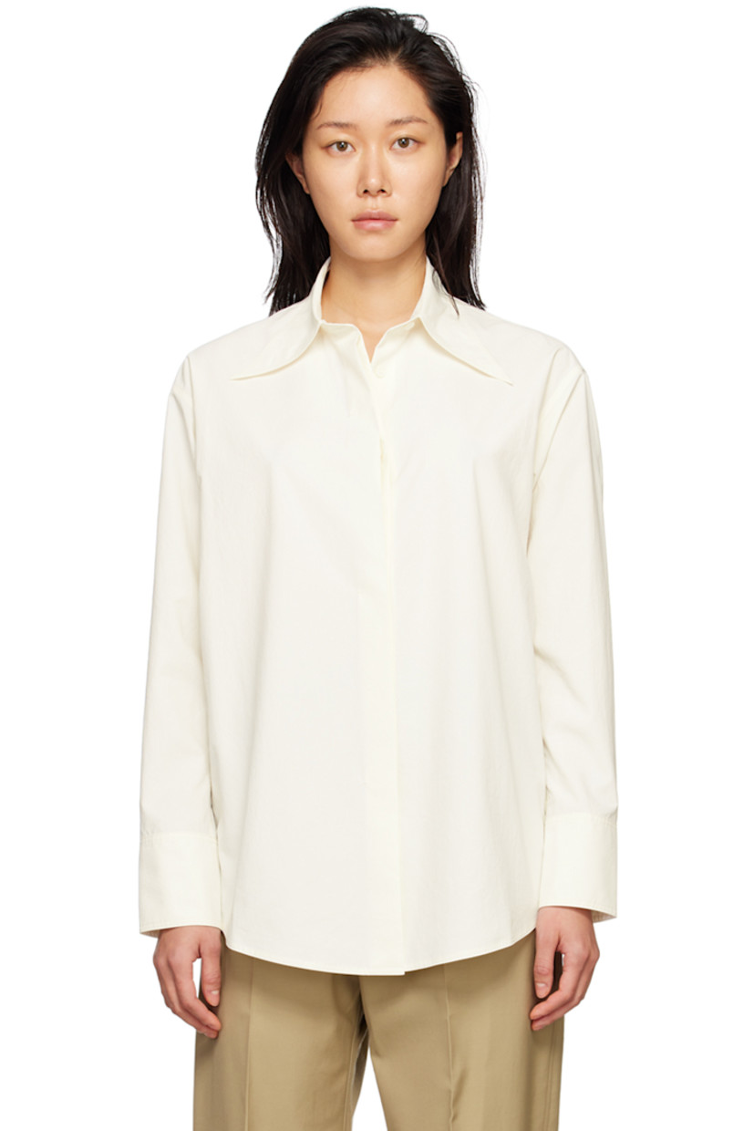 Polyester poplin shirt.

· Pointed collar
· Concealed button placket
· Shirttail hem
· Two-button barrel cuffs

Supplier color: Cream