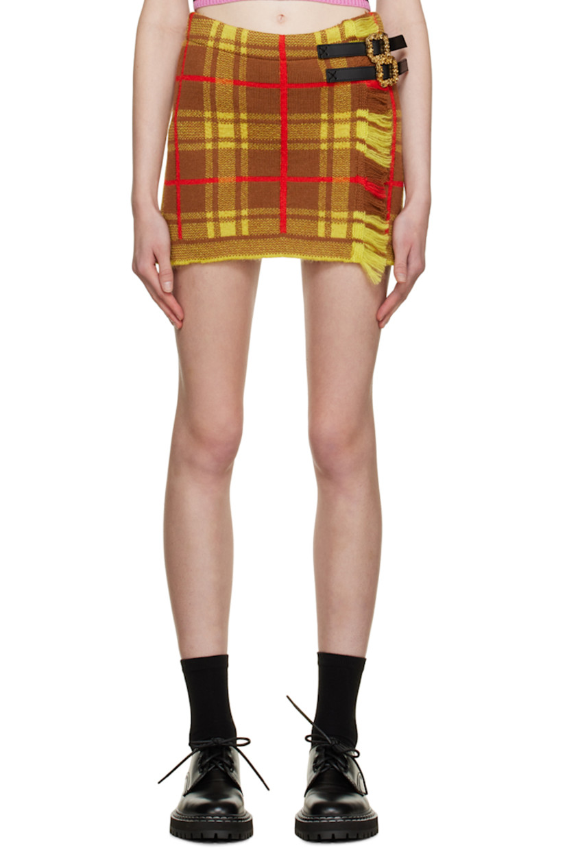 Knit virgin wool and mohair-blend skirt. Jacquard check pattern throughout.

· Leather cinch straps at waist
· Fringed edge at front
· Unlined

Supplier color: Brown