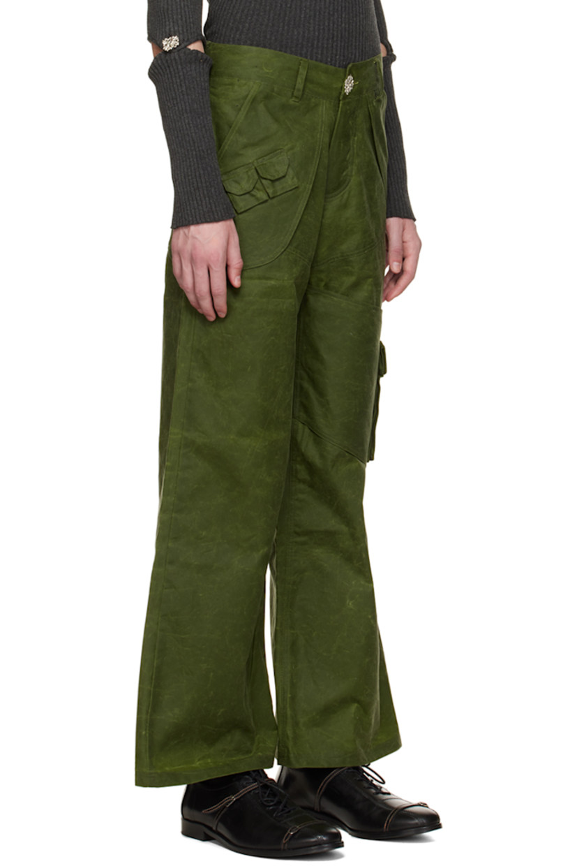 Organic cotton oilskin cargo pants.

· Layered construction
· Belt loops
· Four-pocket styling
· Button-fly
· Flap pocket at front
· Flap pocket at outseam
· Cinch fastening at back waistband
· Silver-tone hardware

Available exclusively at SSENSE.

Supplier color: Forest green