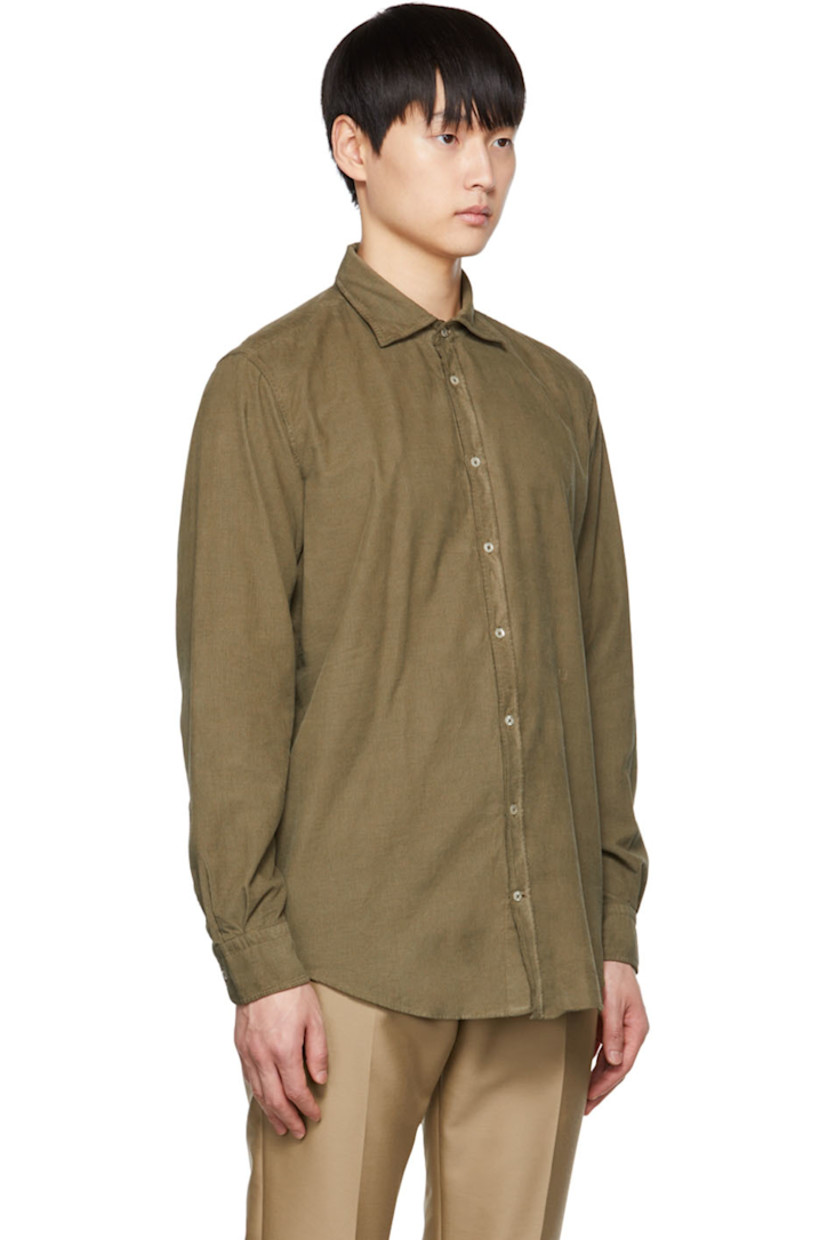 Watercolor-dyed cotton corduroy shirt. 

· Spread collar 
· Button closure 
· Logo embroidered at front
· Curved hem 
· Two-button barrel cuffs 
· Mother-of-pearl hardware 

Supplier color: Military