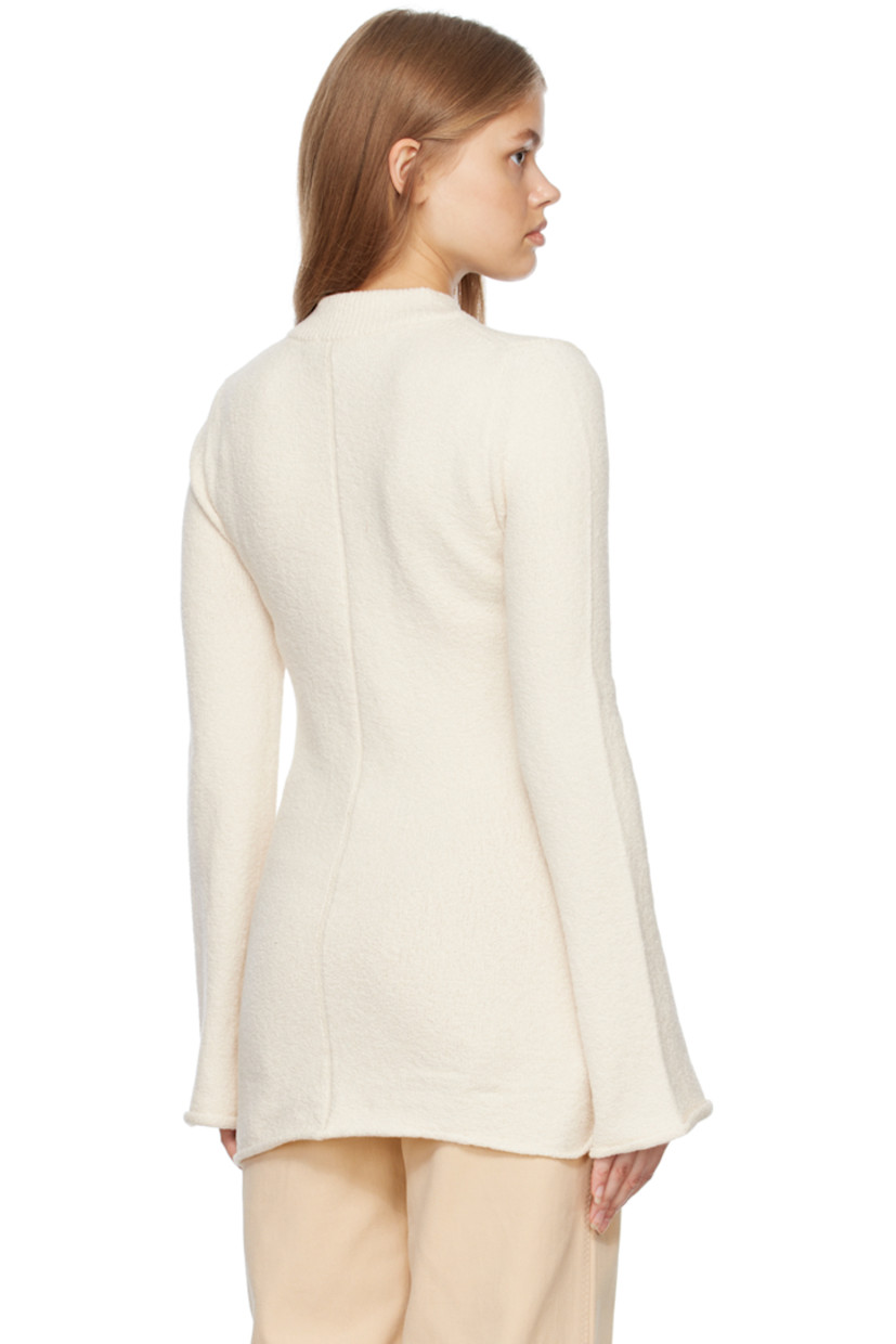 Knit stretch organic cotton sweater. 

· Rib knit crewneck 
· Rolled edge at cuffs and hem 

Supplier color: Ivory