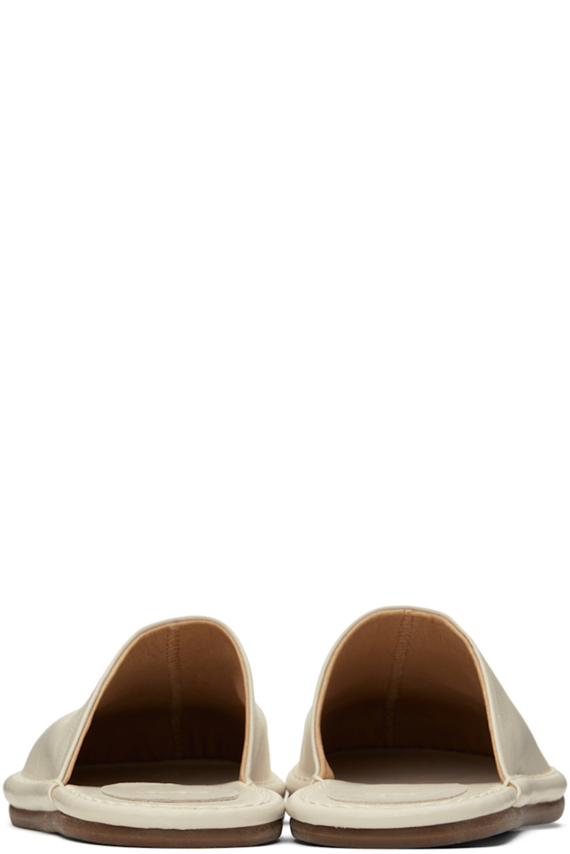 Buffed leather slippers in off-white.

· Leather lining
· Tonal topstitching at welt
· Rubber sole

Available exclusively at SSENSE.

Supplier color: Off white