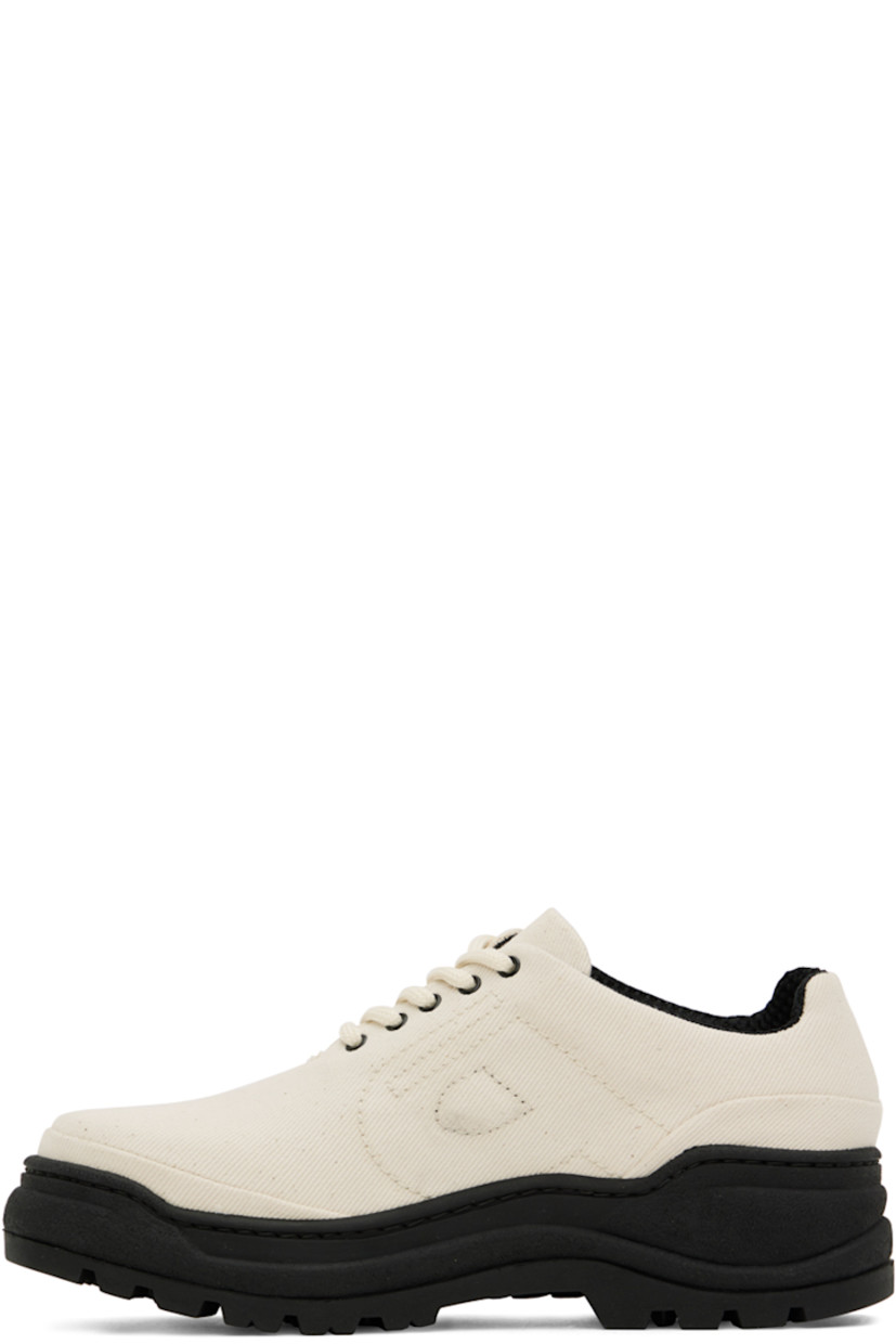 Low-top canvas sneakers in off-white and black.

· Lace-up closure
· Padded tongue and collar
· Logo bonded at outer side
· Logo embroidered at inner side
· Mesh lining in black
· Rubber midsole
· Treaded rubber outsole

Supplier color: Ecru