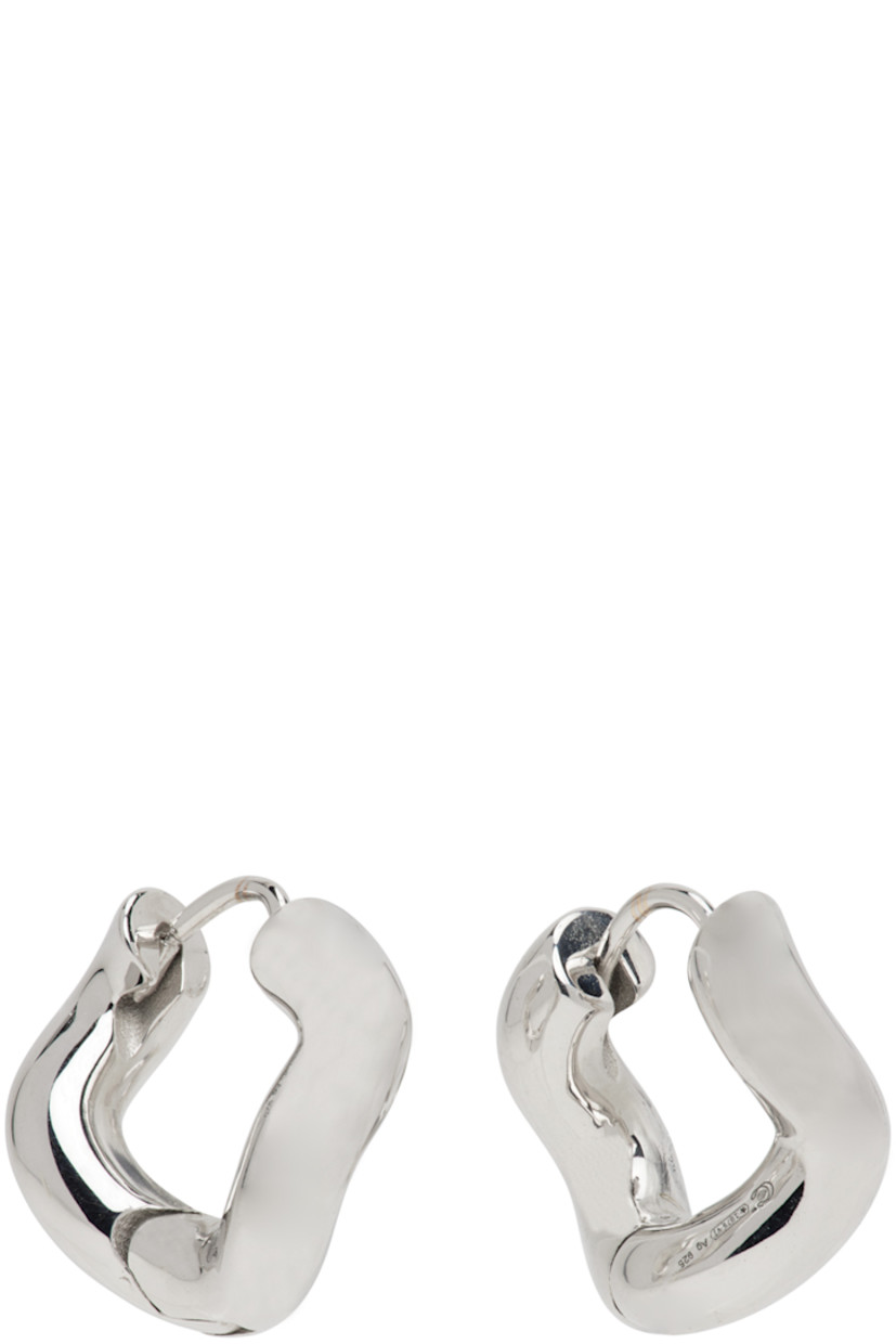Pair of hoop earrings in rhodium-plated sterling silver.

· Hinged ring fastening
· Polishing cloth included
· D0.5"

Supplier color: Silver