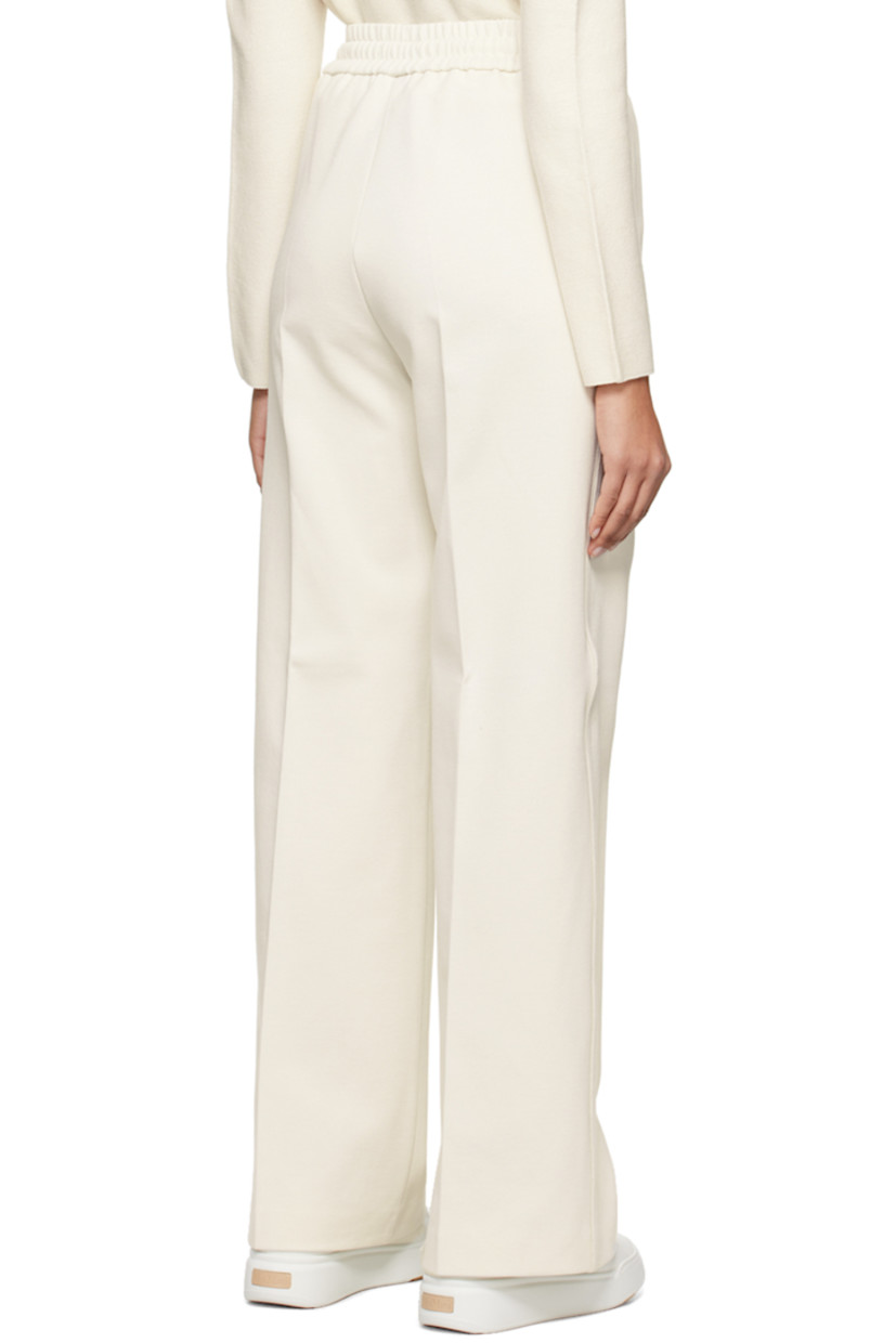 Knit stretch cotton- and nylon-blend trousers.

· Drawstring at elasticized waistband
· Two-pocket styling
· Central seam at front and back legs
· Silver-tone logo hardware at back
· Unlined

Supplier color: Open white
