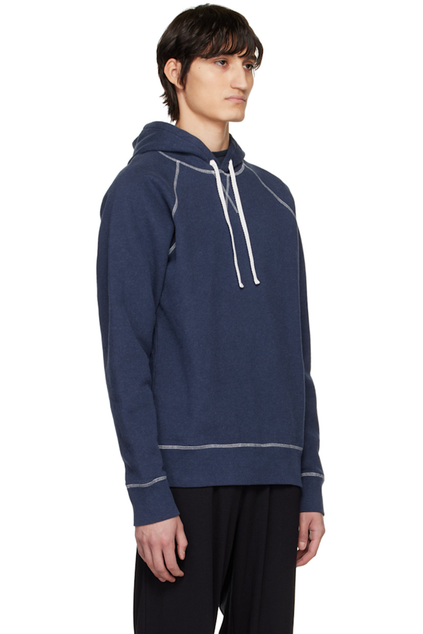 Cotton fleece hoodie. 

· Drawstring at hood
· Raglan sleeves 
· Contrast stitch at white

Supplier color: Navy melange