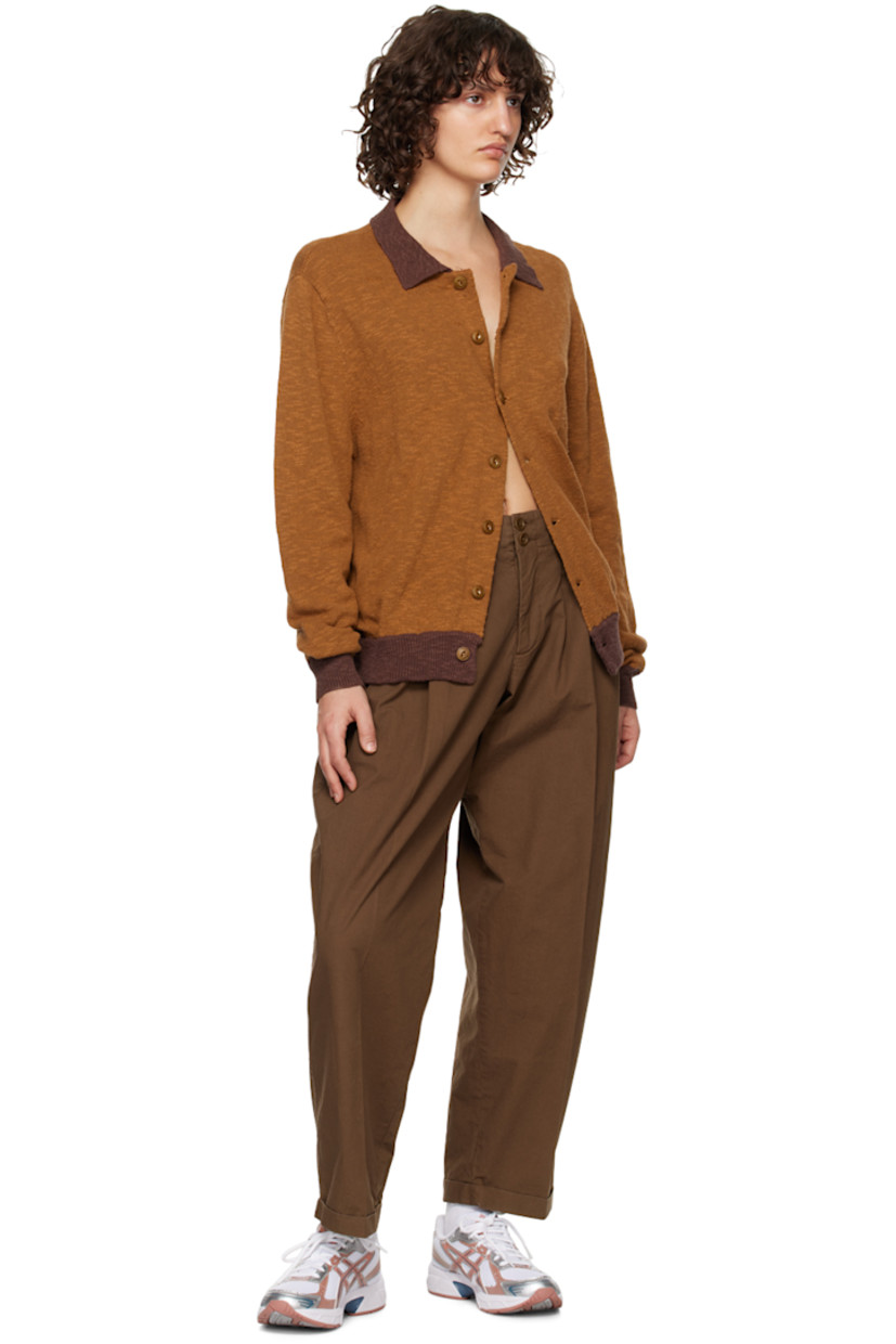 Garment-dyed cotton twill trousers. Topstitching throughout.

· Belt loops
· Double button closure
· Three-pocket styling
· Zip-fly
· Darts at front and back
· Pleats at front
· Rolled cuffs

Supplier color: Brown