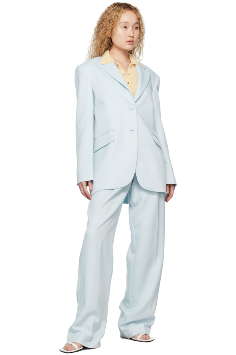 Polyester twill trousers. 

· Belt loops
· Three-pocket styling
· Zip-fly
· Pleats at front
· Creased legs

Supplier color: Sky melt