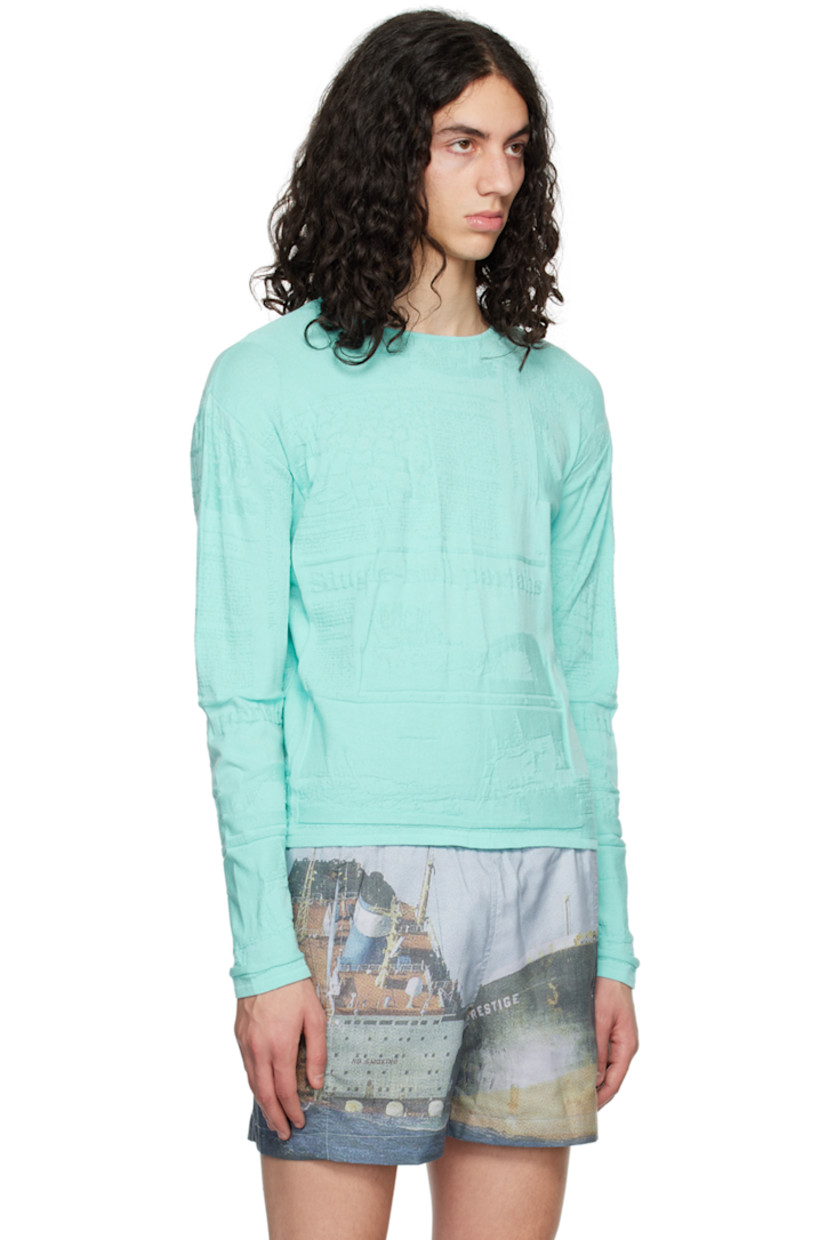 Viscose- and recycled polyester-blend cloqué T-shirt. 

· Logo and graphic pattern throughout
· Rib knit crewneck, hem, and cuffs

Supplier color: Newspaper ciel