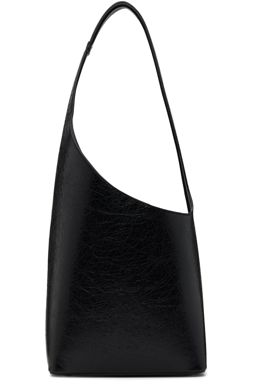 Crackled calfskin shoulder bag in black. 

· Fixed shoulder strap
· Logo embossed at face
· Bumper studs at base
· Magnetic fastening at throat
· Patch pocket at interior
· Grained faux-leather lining
· H8.5 x W8 x D5 in

Supplier color: Crackled black thunder