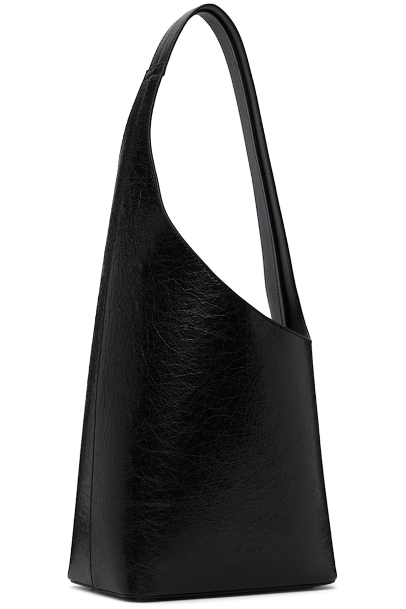 Crackled calfskin shoulder bag in black. 

· Fixed shoulder strap
· Logo embossed at face
· Bumper studs at base
· Magnetic fastening at throat
· Patch pocket at interior
· Grained faux-leather lining
· H8.5 x W8 x D5 in

Supplier color: Crackled black thunder