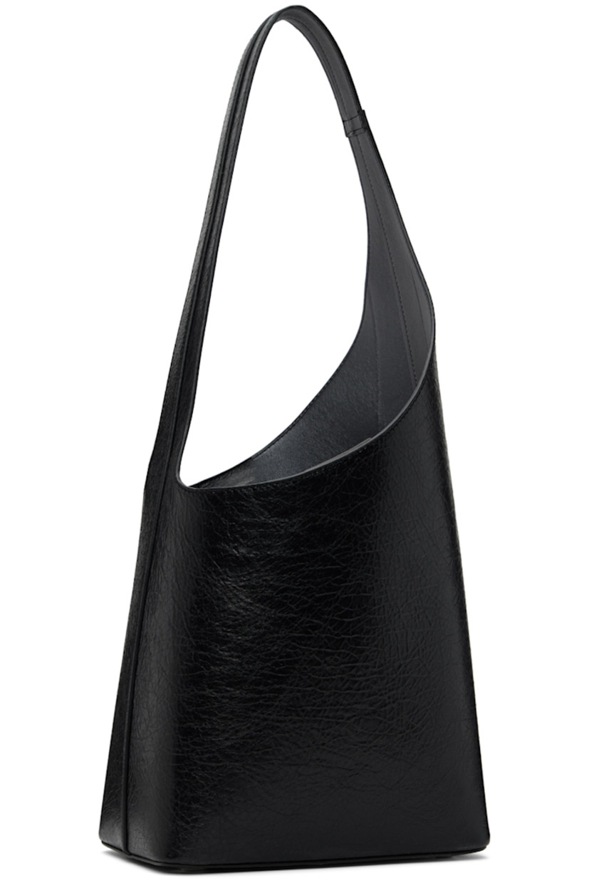 Crackled calfskin shoulder bag in black. 

· Fixed shoulder strap
· Logo embossed at face
· Bumper studs at base
· Magnetic fastening at throat
· Patch pocket at interior
· Grained faux-leather lining
· H8.5 x W8 x D5 in

Supplier color: Crackled black thunder