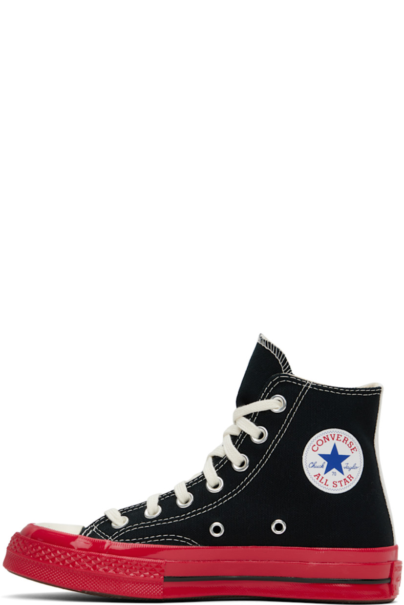High-top canvas sneakers in black and red.

· Round rubber cap toe
· Lace-up closure
· Webbing trim at heel counter
· Logo graphic printed at outer side
· Logo bonded at inner side
· Eyelet vents at inner side
· Logo embossed at heel
· Textured rubber midsole
· Treaded rubber outsole

Part of the Comme des Garçons Play x Converse collaboration.

Supplier color: Black