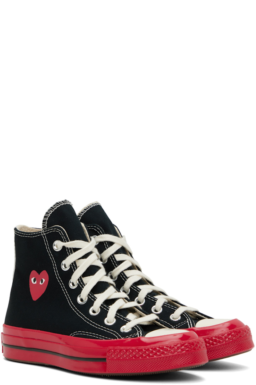 High-top canvas sneakers in black and red.

· Round rubber cap toe
· Lace-up closure
· Webbing trim at heel counter
· Logo graphic printed at outer side
· Logo bonded at inner side
· Eyelet vents at inner side
· Logo embossed at heel
· Textured rubber midsole
· Treaded rubber outsole

Part of the Comme des Garçons Play x Converse collaboration.

Supplier color: Black