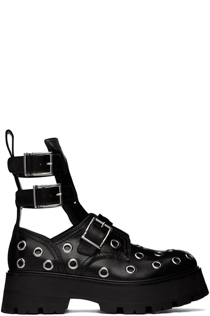 Ankle-high buffed leather boots in black. Eyelet hardware throughout.

· Pin-buckle straps at vamp and collar
· Logo embossed at tongue 
· Pull-loop at heel collar
· Cutouts at sides
· Foam rubber platform midsole 
· Treaded rubber outsole 
· Platform: H2 in 

Supplier color: Black/Silver
