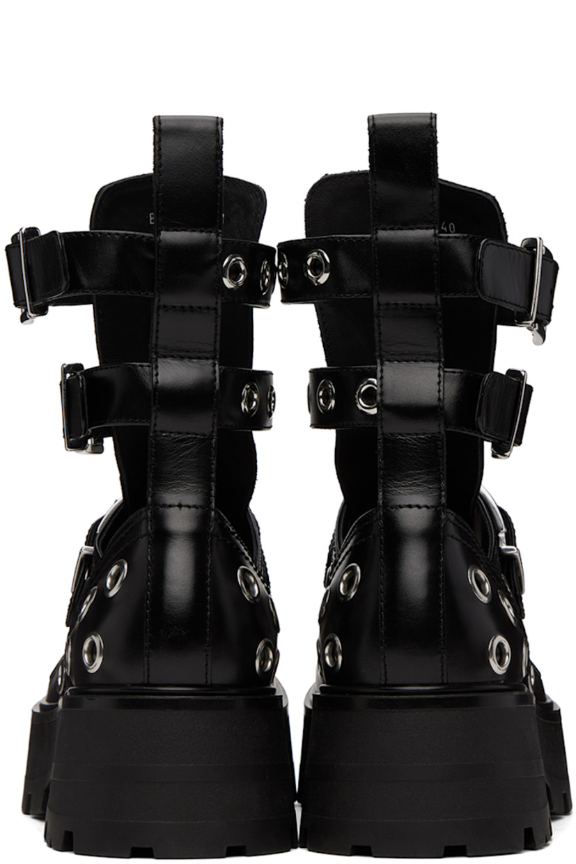 Ankle-high buffed leather boots in black. Eyelet hardware throughout.

· Pin-buckle straps at vamp and collar
· Logo embossed at tongue 
· Pull-loop at heel collar
· Cutouts at sides
· Foam rubber platform midsole 
· Treaded rubber outsole 
· Platform: H2 in 

Supplier color: Black/Silver