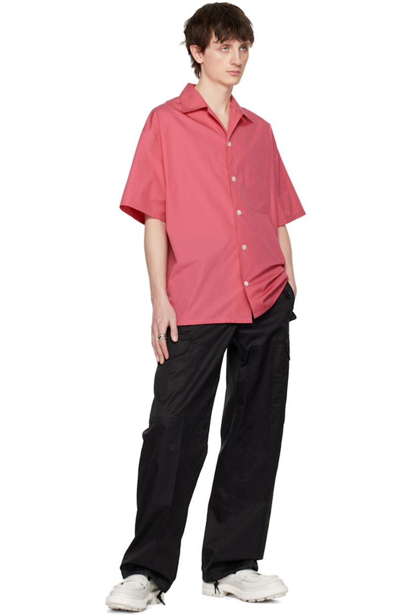 Wide-leg cotton chintz cargo pants.

· Belt loops
· Four-pocket styling
· Zip-fly
· Creased legs
· Drawstring at cuffs
· Flap pocket at outseams

Supplier color: Black