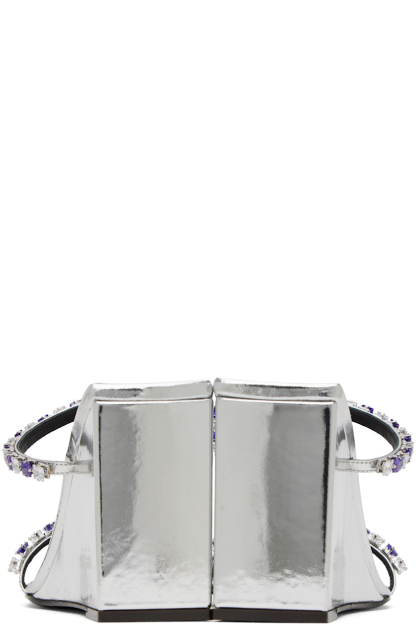 Patent leather slip-on heeled sandals in silver-tone.

· Open square toe
· Straps with crystal-cut accents at vamp
· Logo embossed at cushioned footbed
· Covered block heel with rubber injection
· Leather sole
· Heel: H3.3 in

Supplier color: Silver