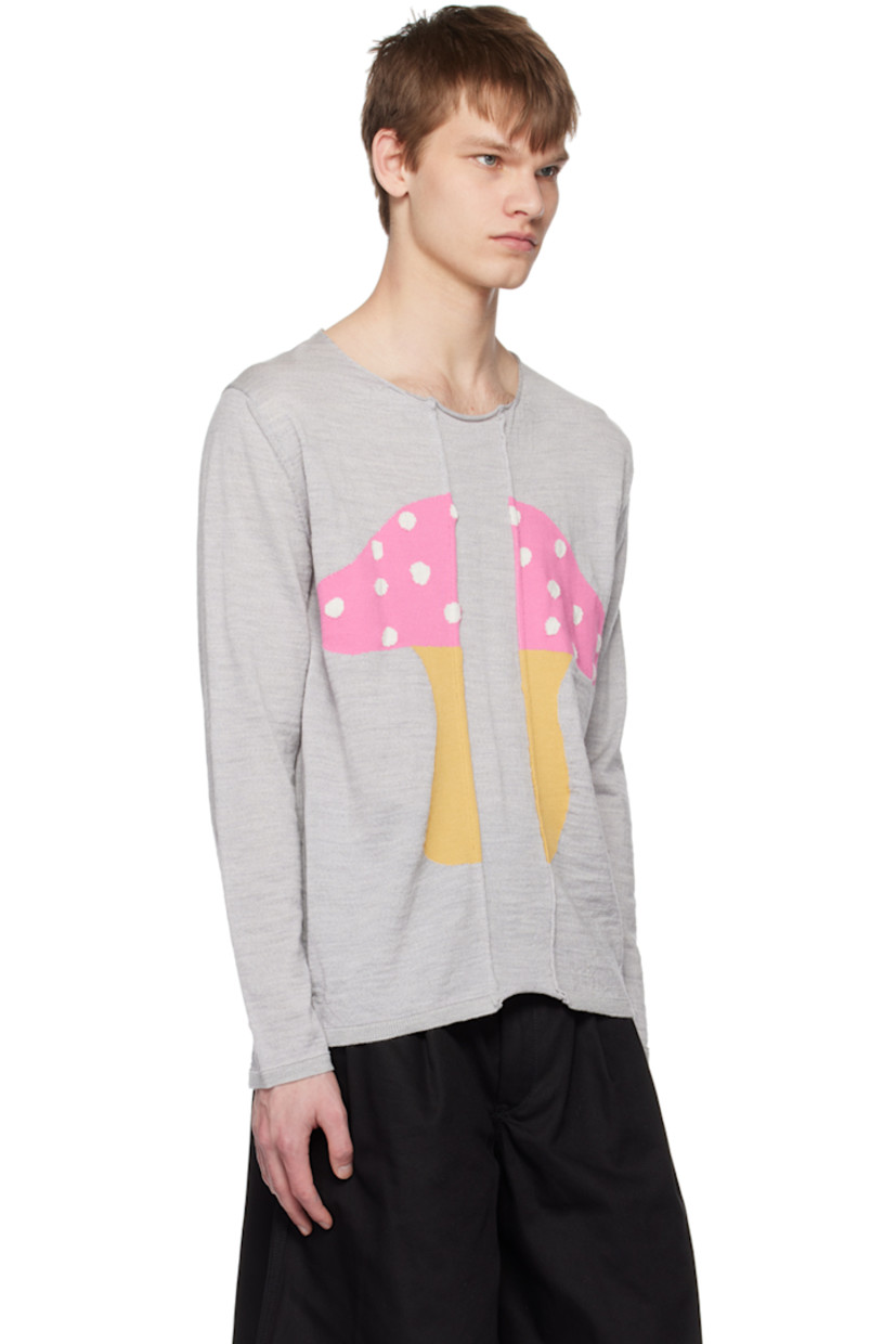 Knit wool- and cotton-blend sweater. 

· Paneled construction 
· Rolled edge at crewneck and front
· Intarsia graphic at front 
· Vented side seams
· Rib knit cuffs 

Part of Comme des Garçons Shirt x Brett Westfall collaboration.

Supplier color: Light grey
