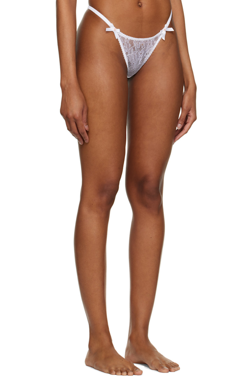 Sheer nylon-blend leavers lace and polyester mesh thong. French seams and scalloped edges throughout.

· Twin bow appliqués at waistband
· Partial cotton jersey lining

Supplier color: White